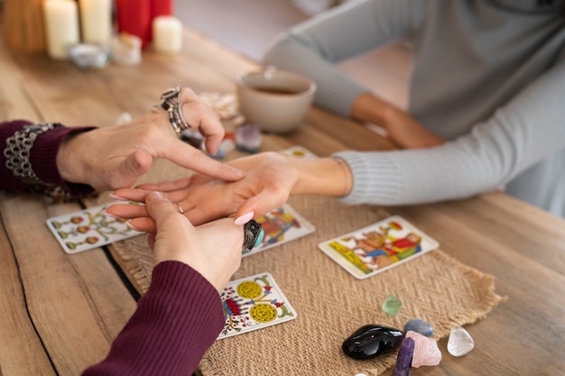 An astrologer consulting with a client, with astrology charts and zodiac symbols in the background, indicating a professional astrology session.